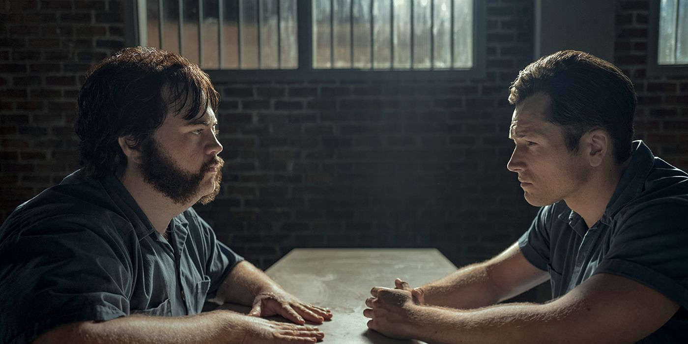 Larry Hill and Jimmy Keene sitting across from one another in prison on Black Bird.