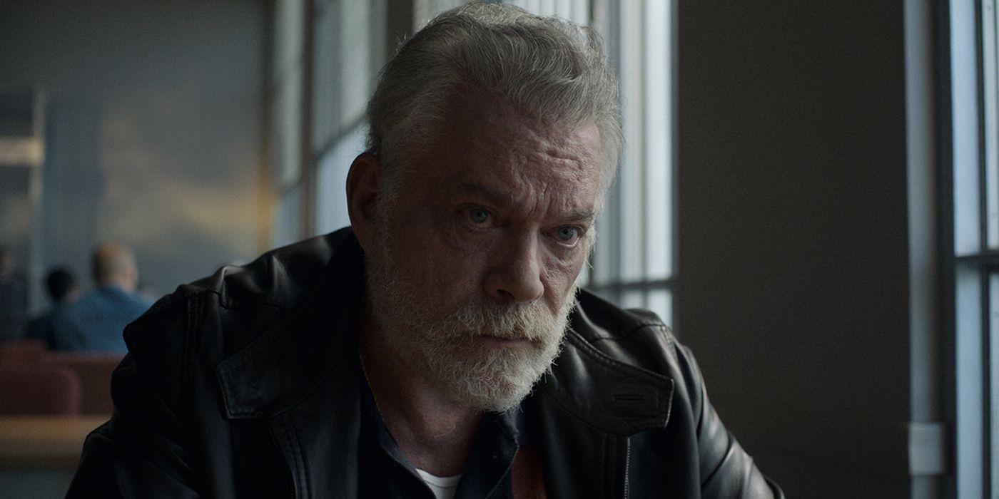 Ray Liotta sitting in prison talking to his son in a scene from Black Bird.