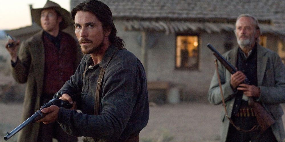 Dan holds a rifle outdoors in 3:10 to Yuma