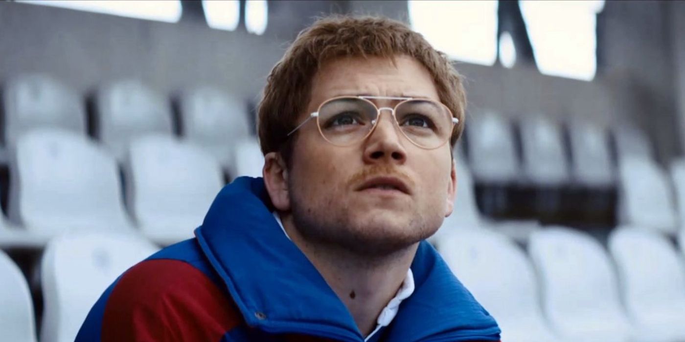 Targon Egerton in Eddie the Eagle, sitting on bleachers, looking up to the sky.