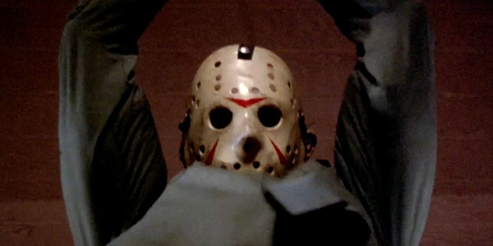 Jason holds his arms up while wearing a hockey mask in Friday the 13th Part III