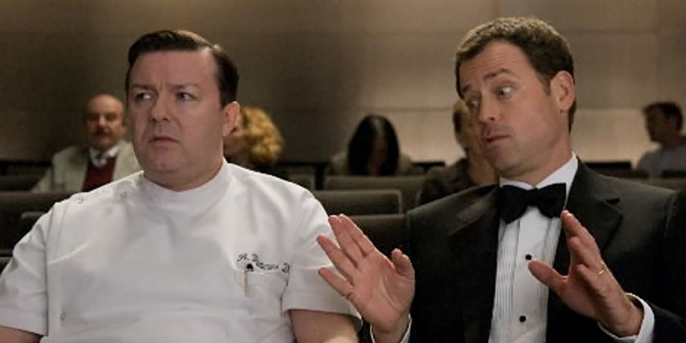 Ricky Gervais and Greg Kinnear sitting together in a scene from Ghost Town.