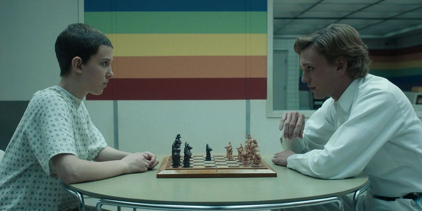 jamie campbell bower and millie bobby brown as one and eleven playing chess in stranger things season 4