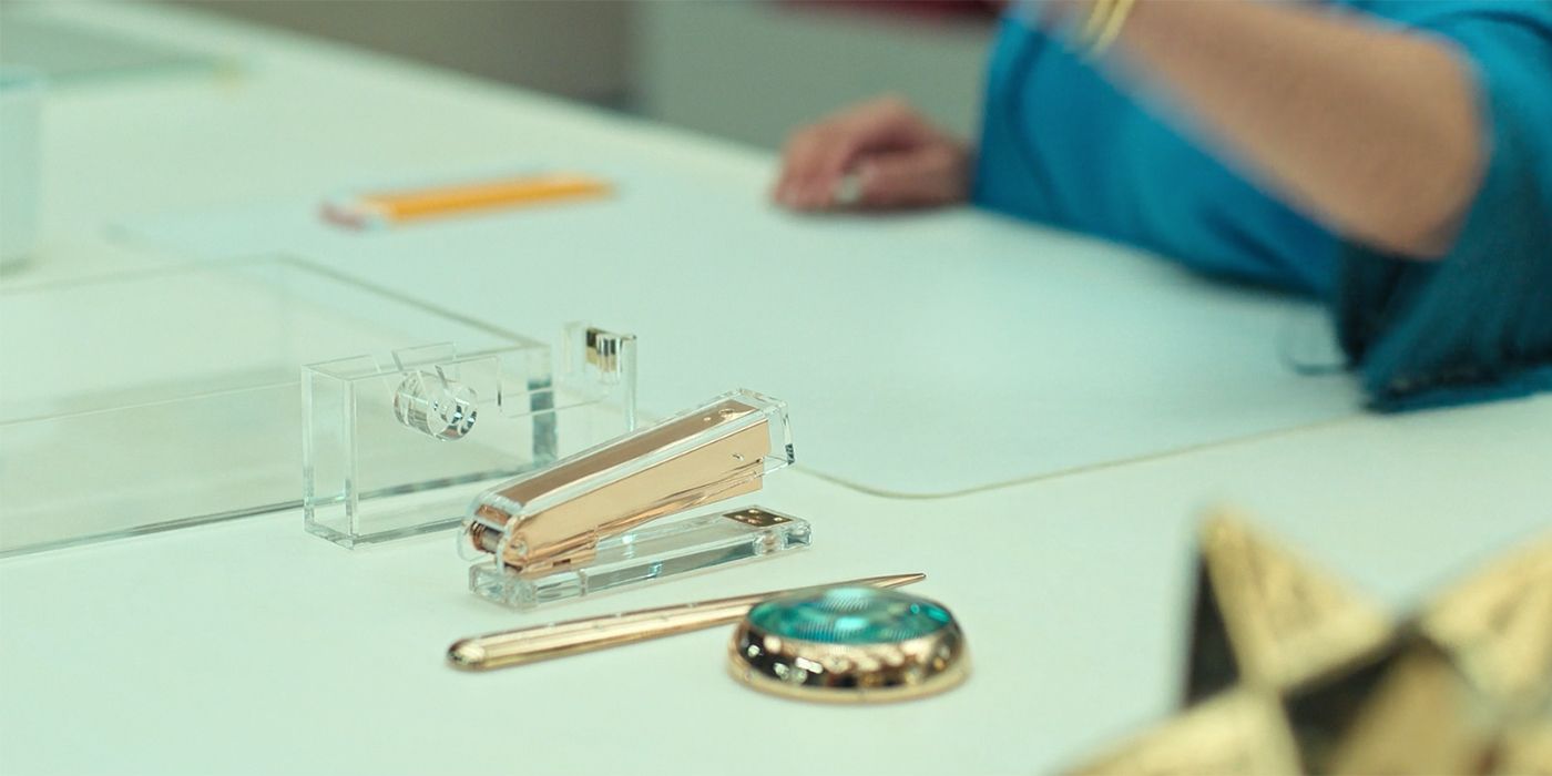 A close-up of Molly's new desk at her office showing a gold stapler and pens on Loot.