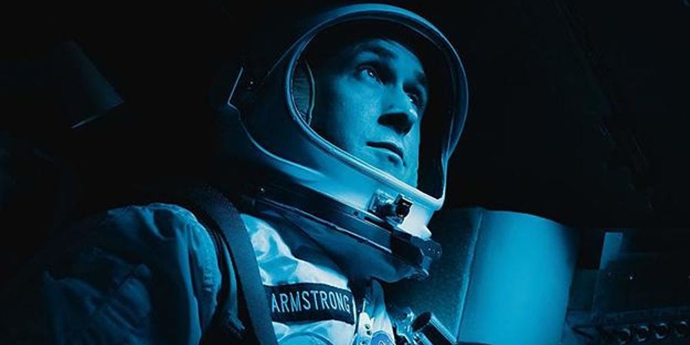 Neil sits in the shuttle in a blue glow in First Man