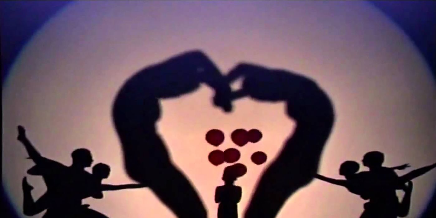 Silhouettes performing on stage on AGT, forming a heart and scene.