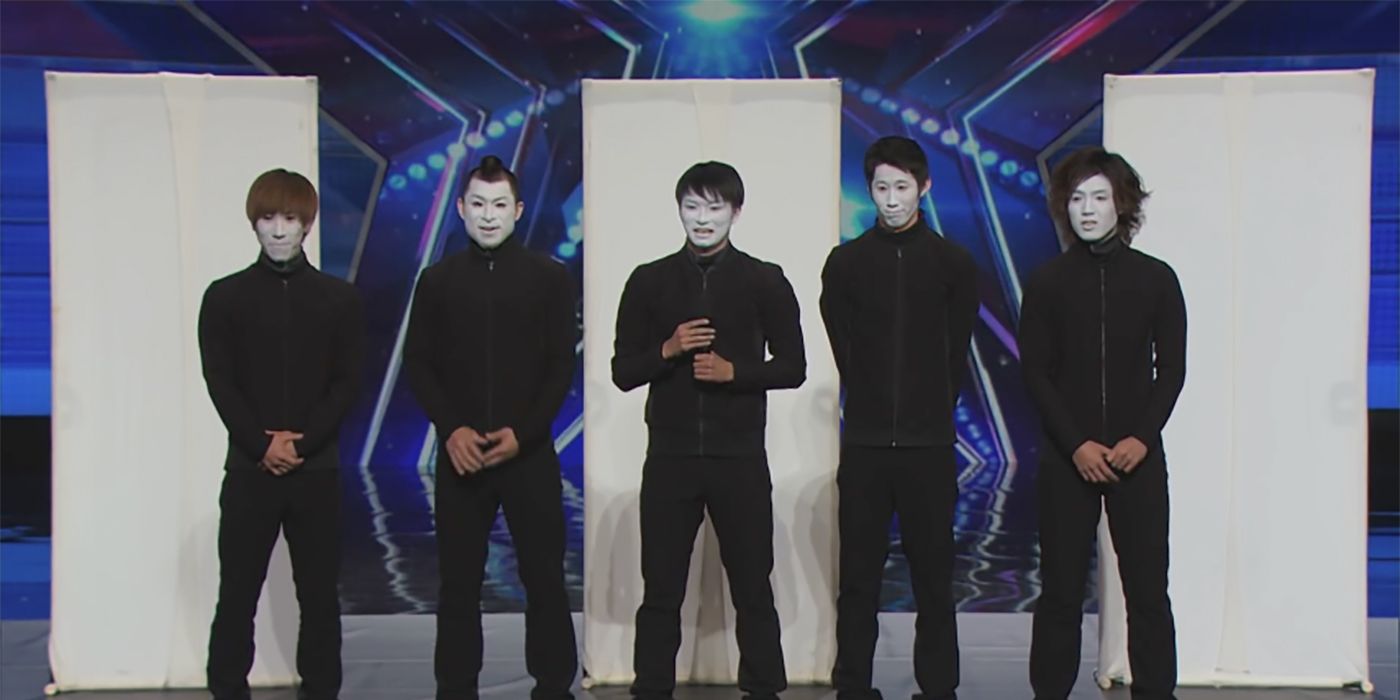 The members of Sira-A wearing black with faces painted in white like mimes on AGT.