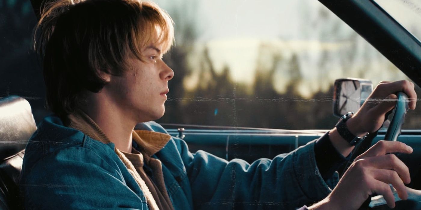 Jonathan in the car driving in a scene from Stranger Things.