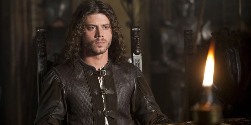 Cesare sits in a chair on The Borgias