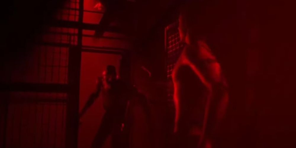 Nick approaches Jacob in a cage in The Quarry