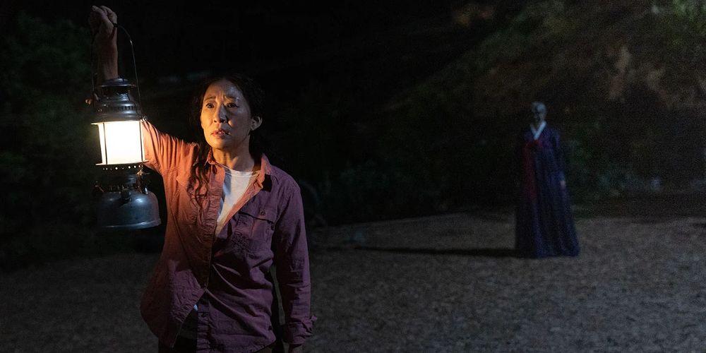 Sandra holds a lantern at night in Umma