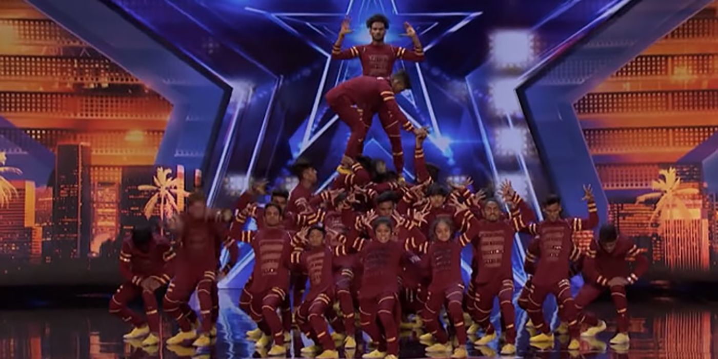 The members of V.Unbeatable posing on stage after a dance routine on AGT.