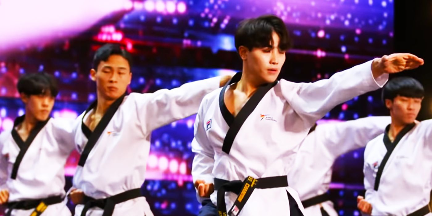 Members of World Taekwondo Demonstration Team with hands out on AGT stage.