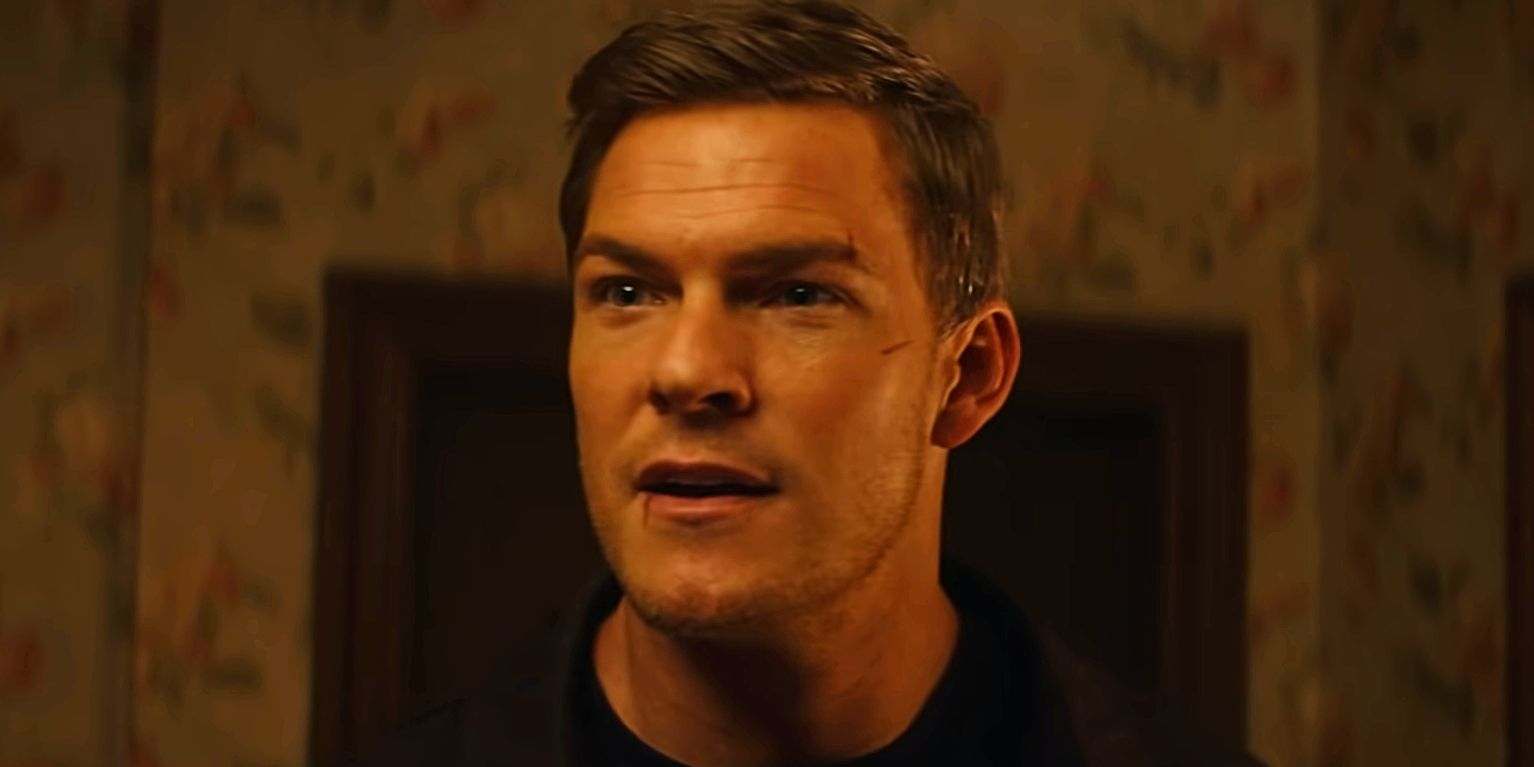 Alan Ritchson starting to smile in Reacher