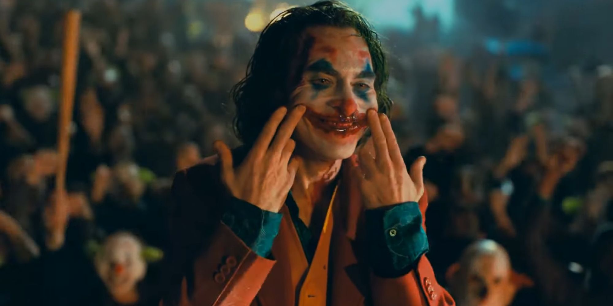 Arthur Fleck becoming the Joker with a blood smile in Joker (2019)