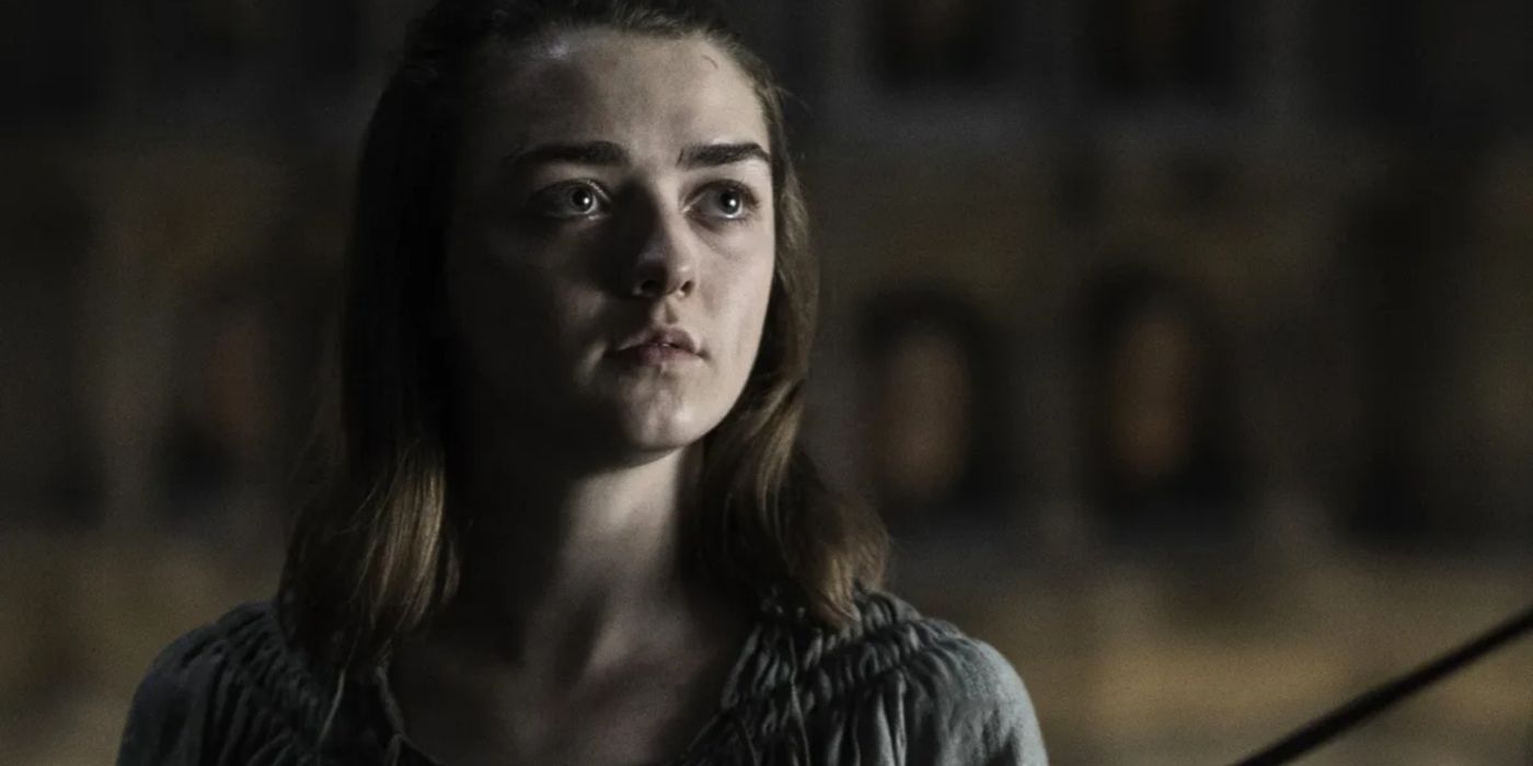 Arya pointing her sword Needle in the temple of of the Many-Faced God.