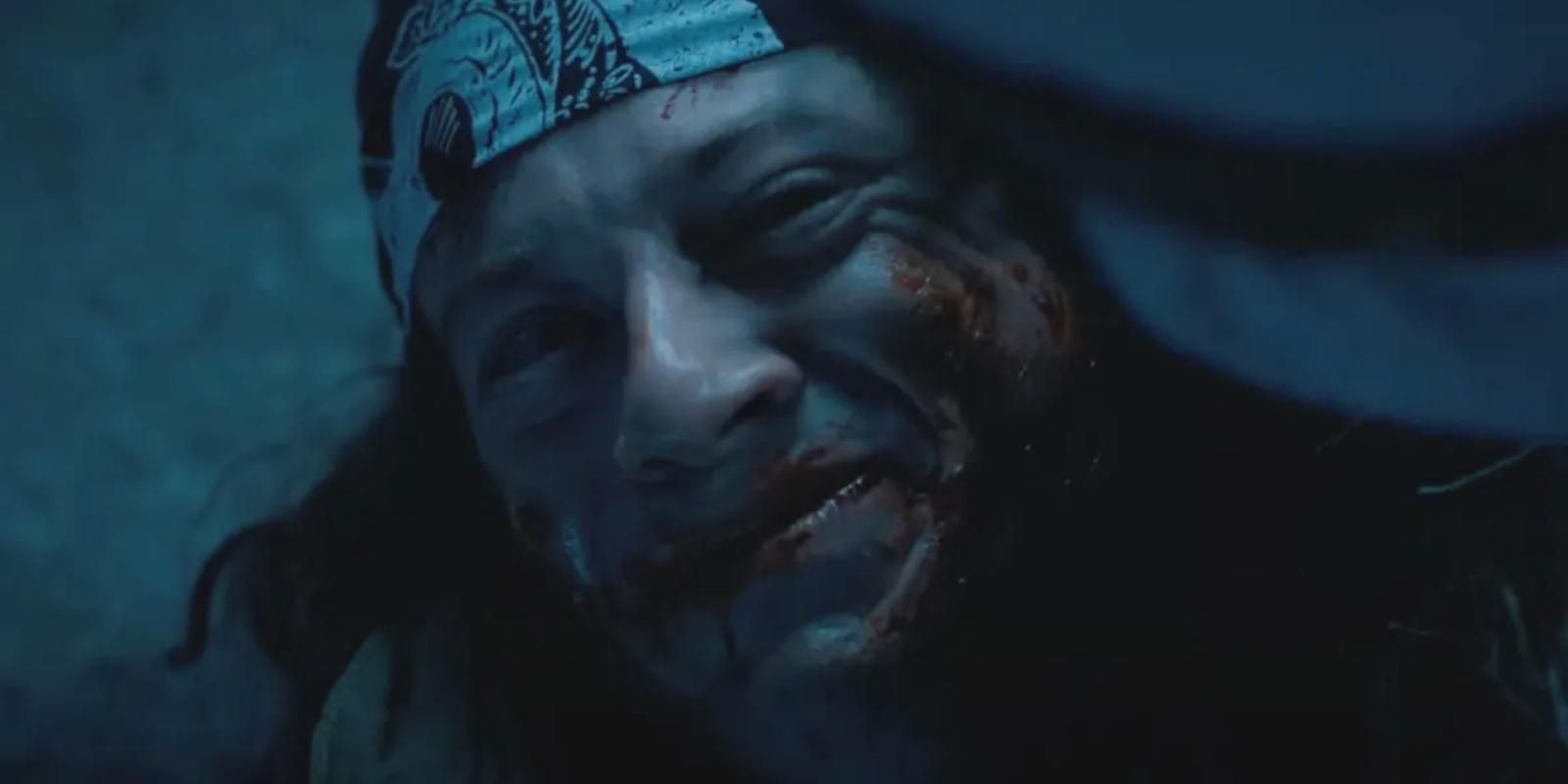 Bloody Eddie Munson smiling tearfully at Dustin Henderson in Stranger Things