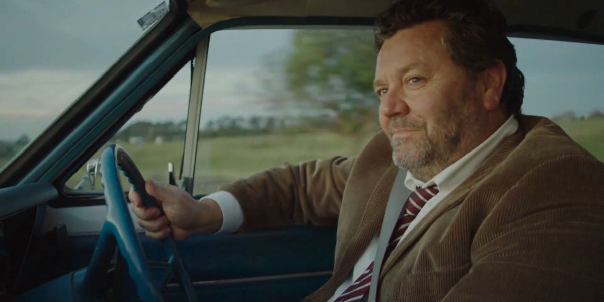 A detective drives a car from the Brokenwood Mysteries 