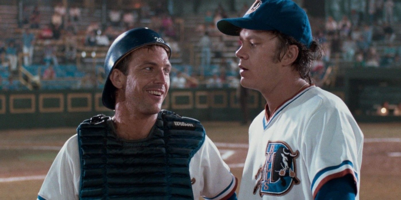 Kevin Costner smiling at Tim Robbins on the mound in Bull Durham