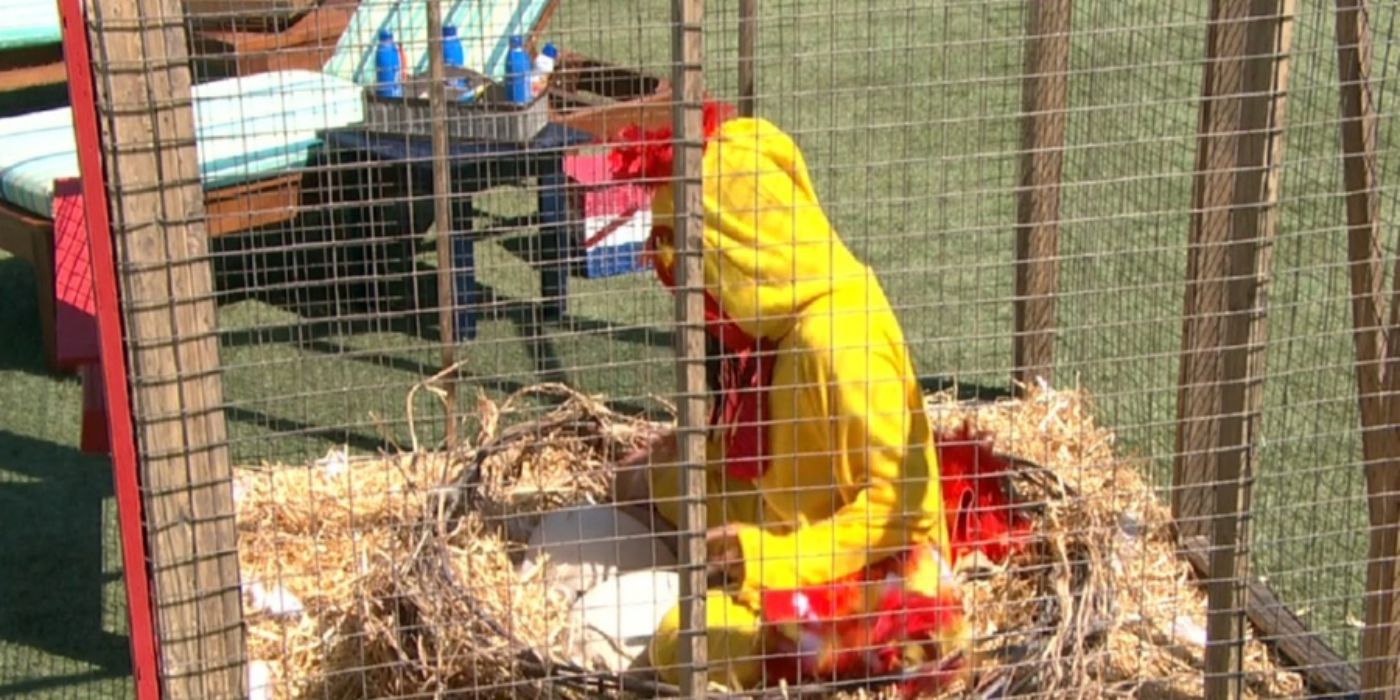 A person in a chicken costume inside a cage in Big Brother.