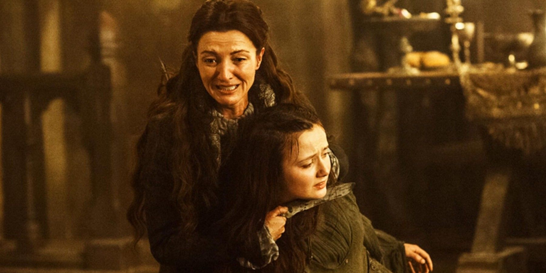 Michelle Fairley as Catelyn Stark holding Frey's wife and screaming at the Red Wedding in Game of Thrones
