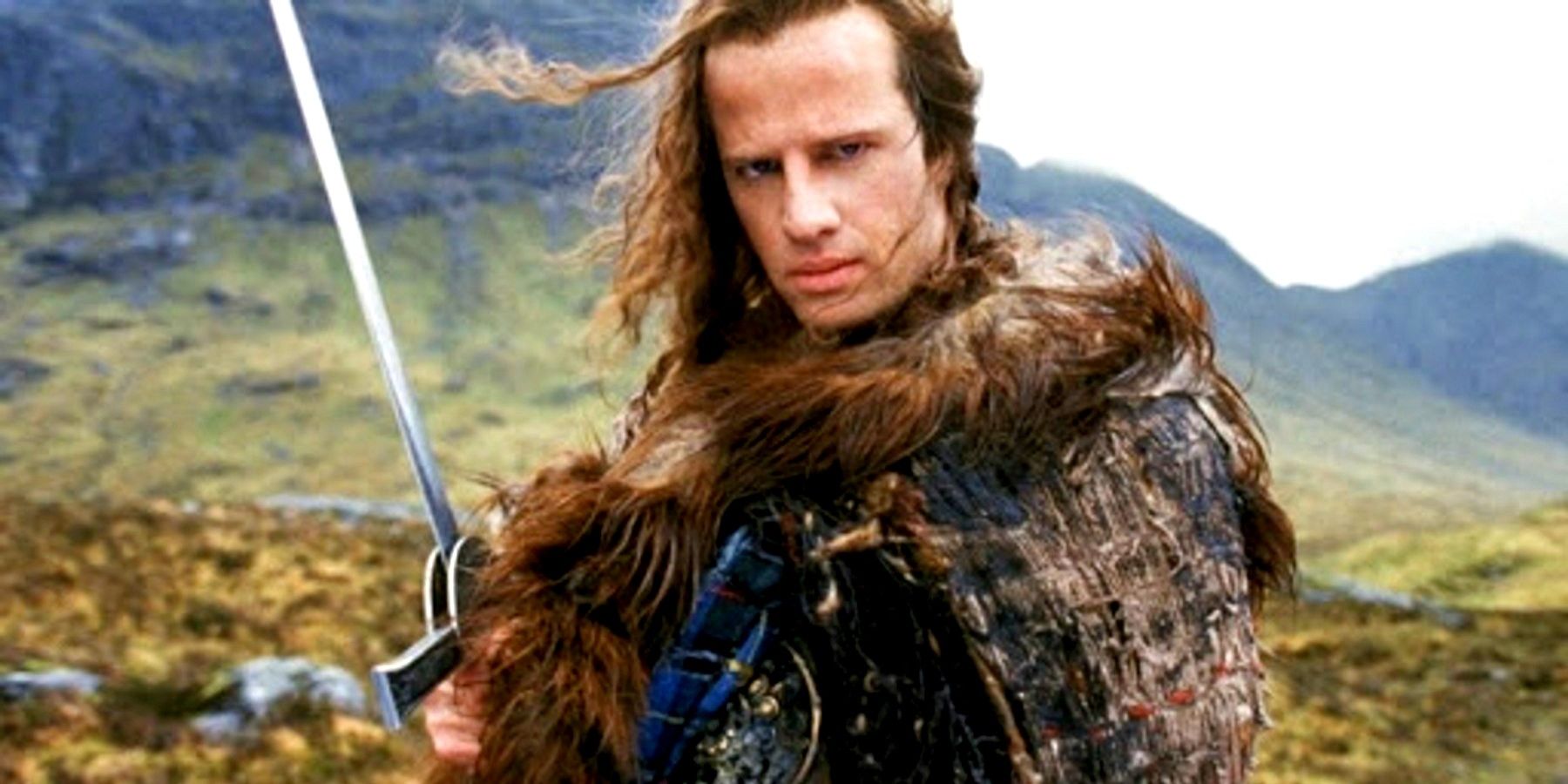 Christopher Lambert holding a sword on a mountain in Highlander.