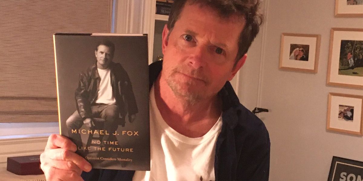 Picture of Michael j Fox holding his book.