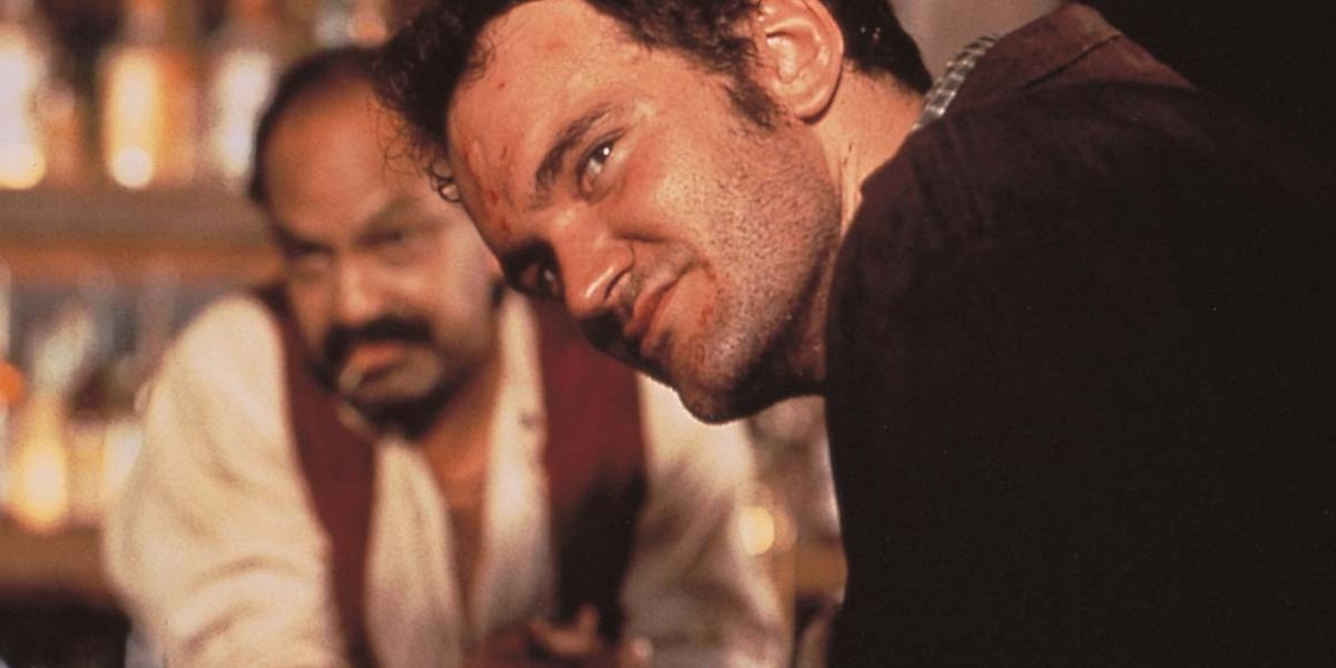 Quentin Tarantino leaning over a bar top in Desperado.  