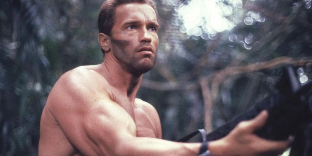 Dutch holds his machine gun ready to fight in the original Predator