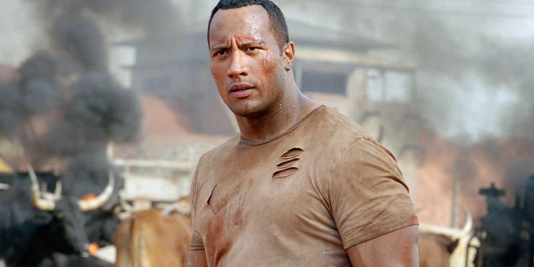 Dwayne Johnson with a torn shirt in The Rundown
