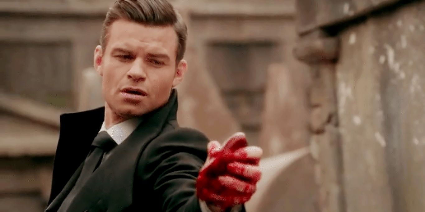 Elijah Mikaelson on The Originals holding a bloody human heart.