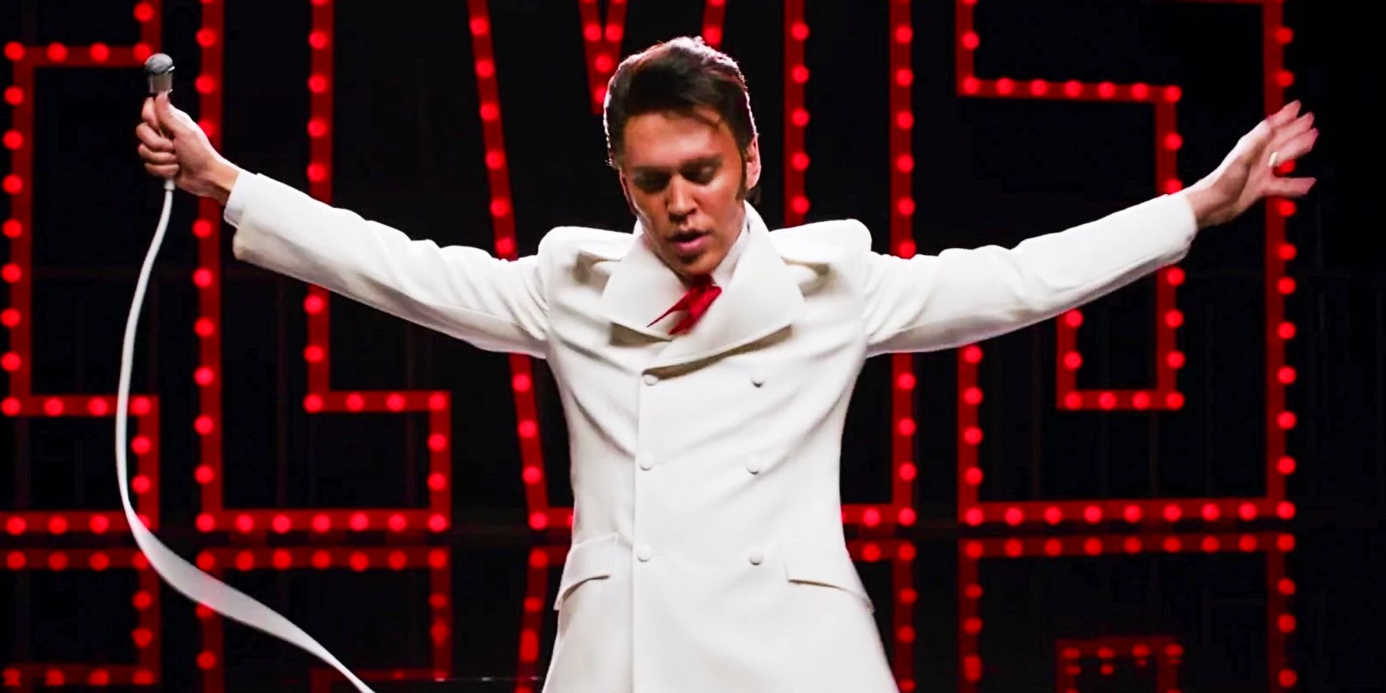 Austin Butler as Elvis in white suit performing 