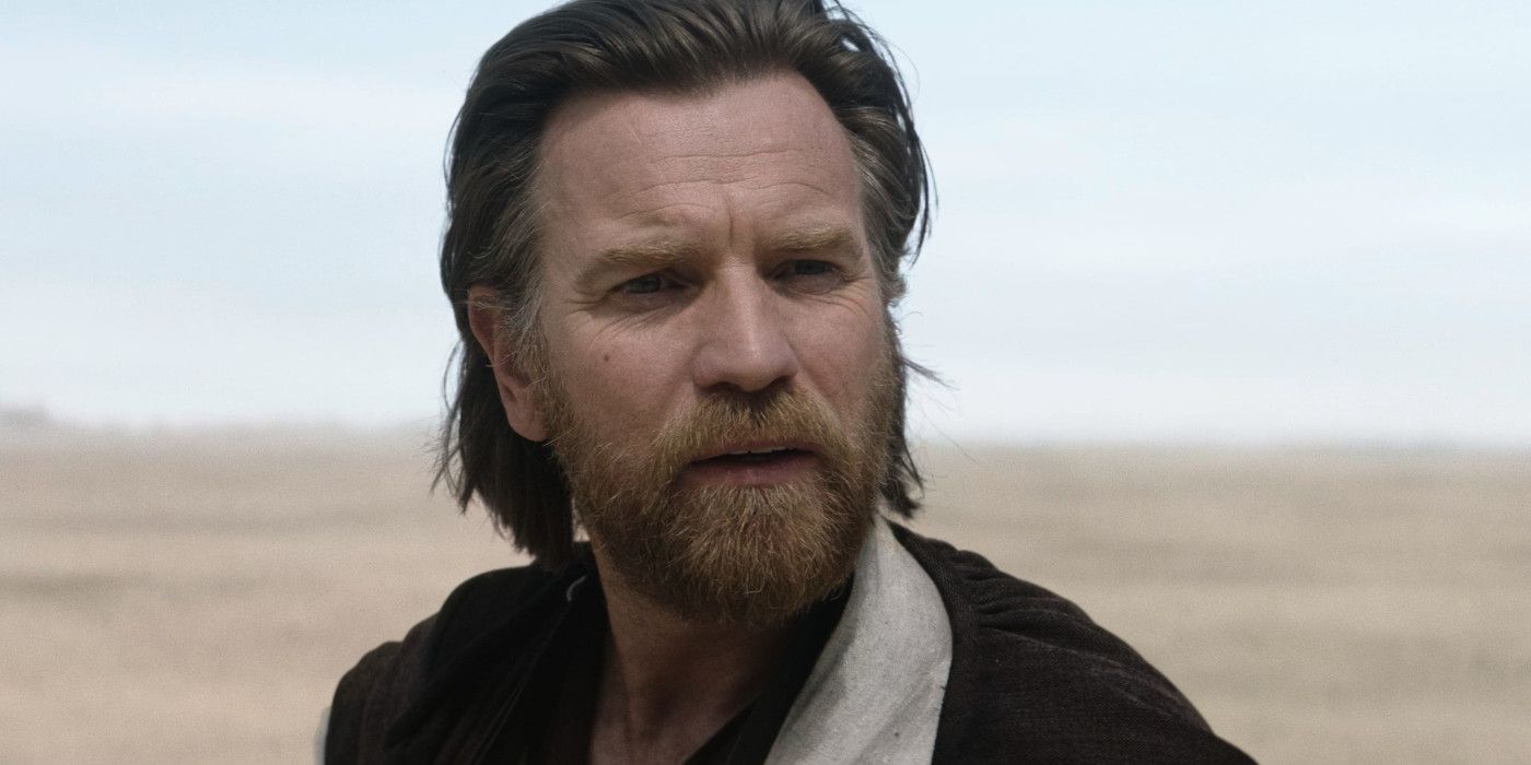 Ewan McGregor como Obi-Wan Kenobi barbudo no deserto conversando.