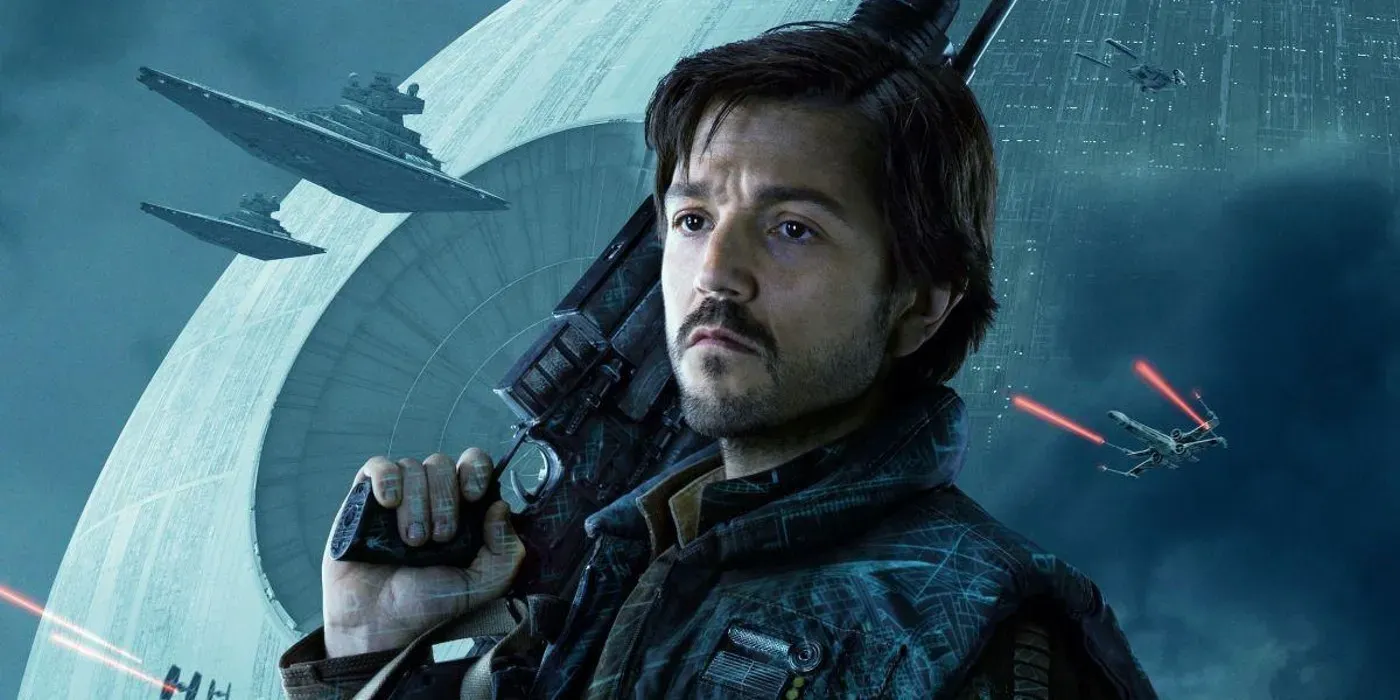 Cassian Andor stands looking serious in front of a backdrop of the Death Star with X-wing and star destroyers