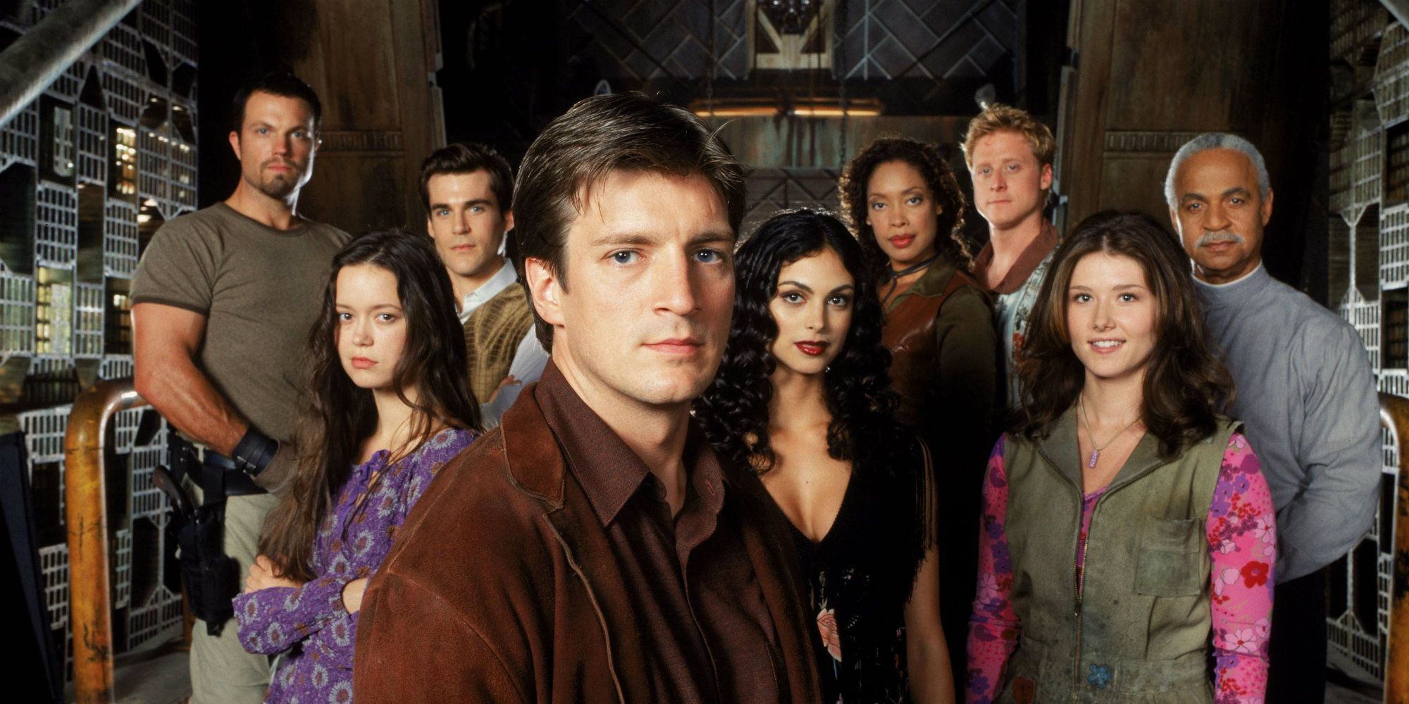 The cast of characters from the 2002 sci-fi series Firefly standing together in a spaceship