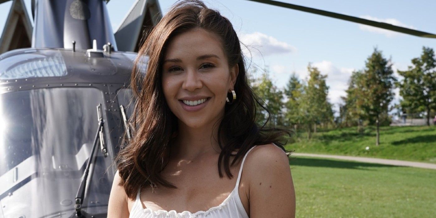 The Bachelorette Gabby Windey posing in front of helicopter 