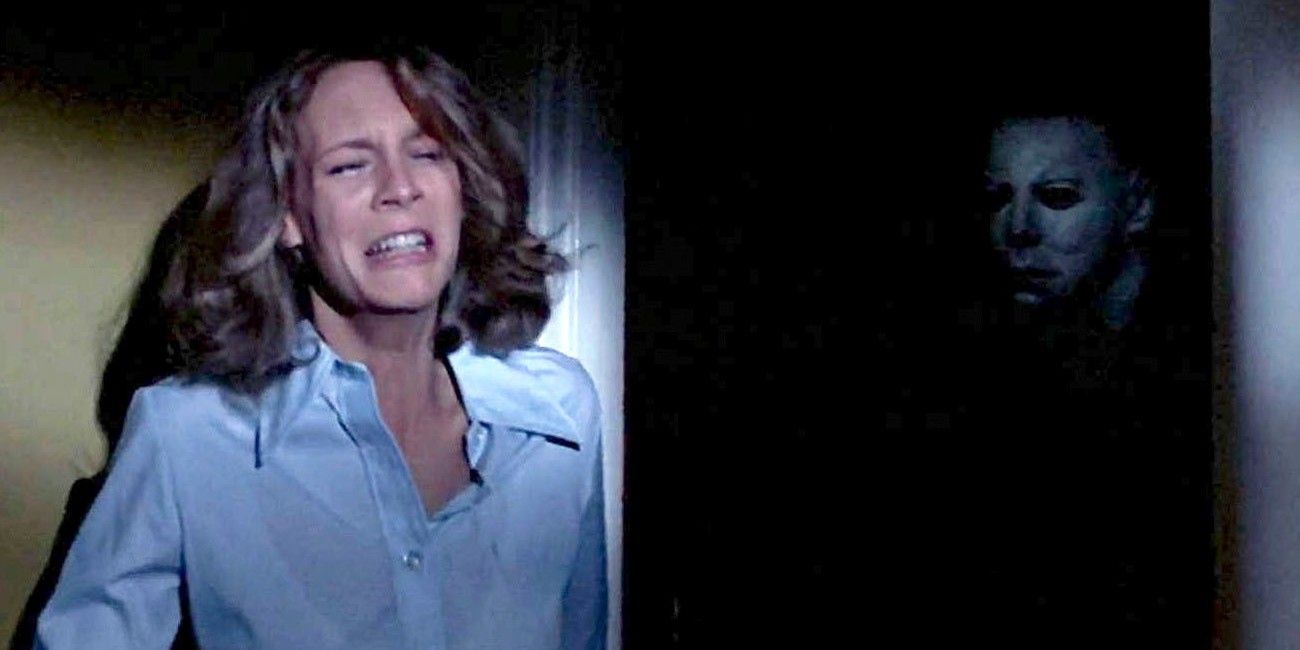 Michael Myers coming out of the shadows behind Laurie in Halloween 