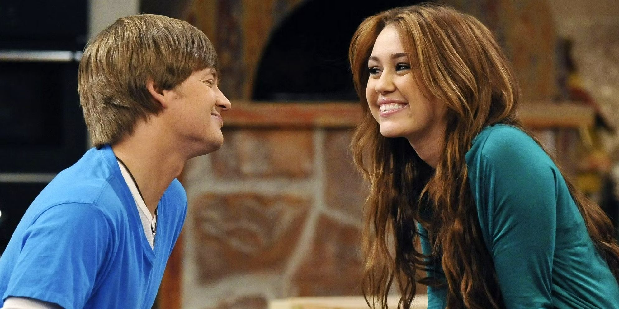 Hannah Montana Miley Cyrus as Miley Stewart and Jason Earles as Jackson smiling at each other