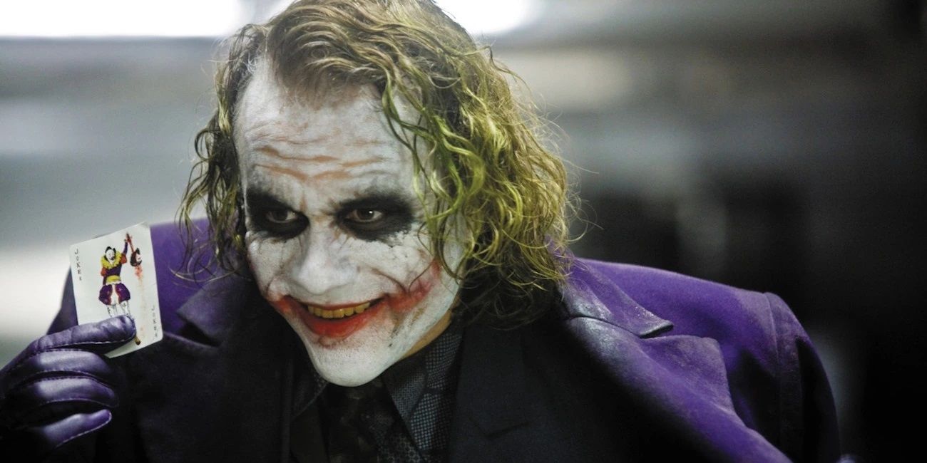 Heath Ledger with a Joker card in The Dark Knight
