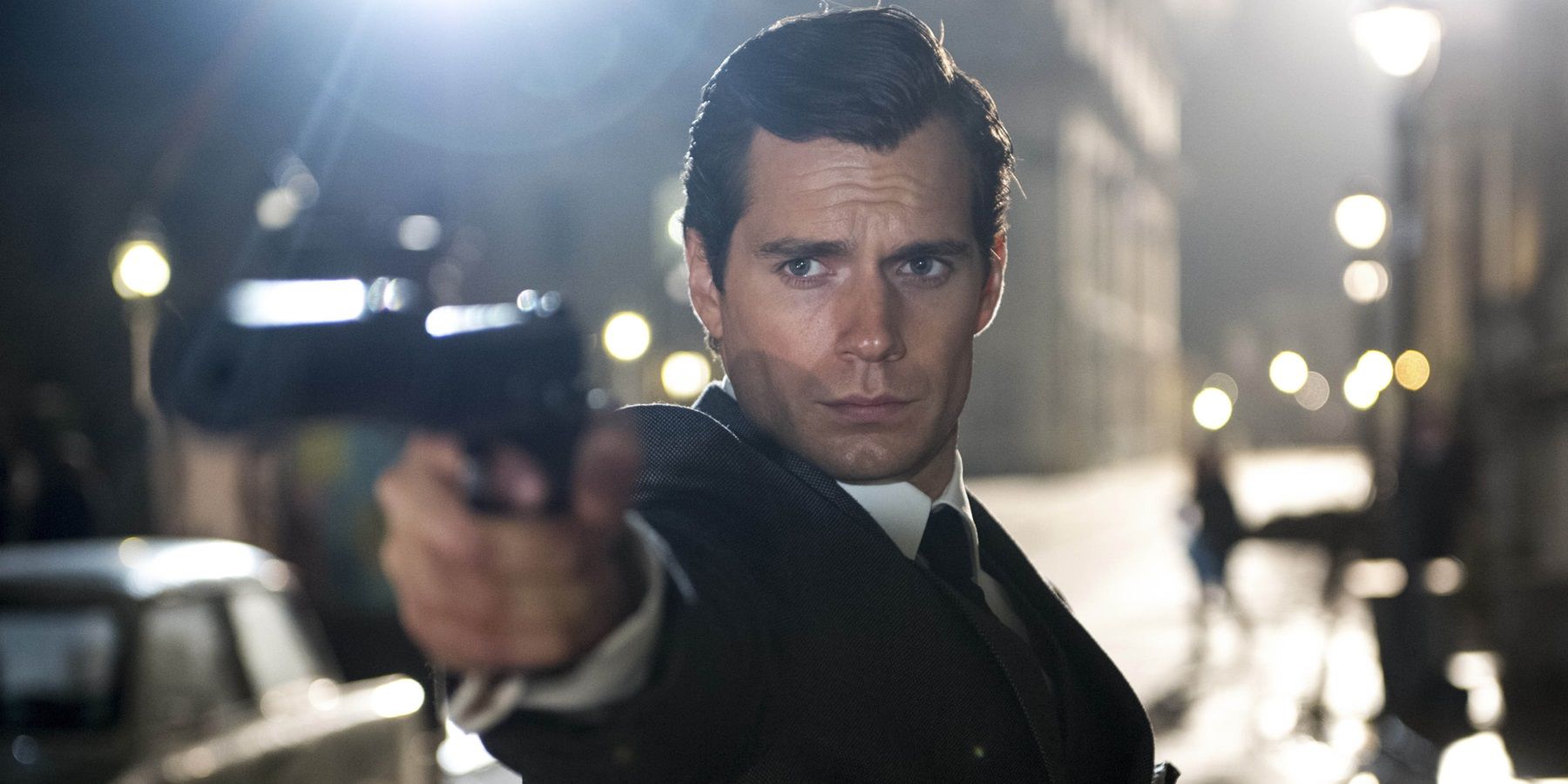 Henry Cavill with a gun in The Man from UNCLE