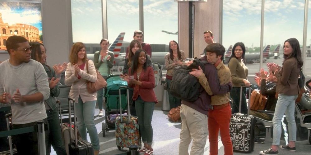 Howard and Raj hug at the airport in The Big Bang Theory