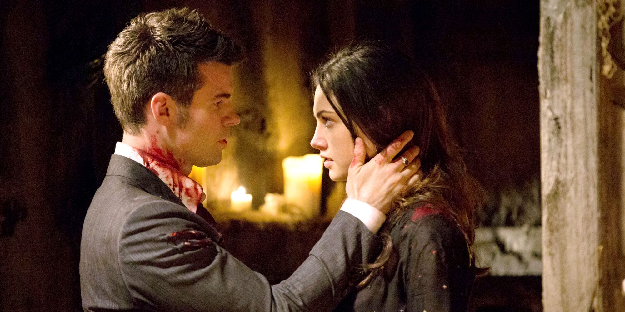 Image of Hayley and Elijah both bloody, he's touching her cheek gently.