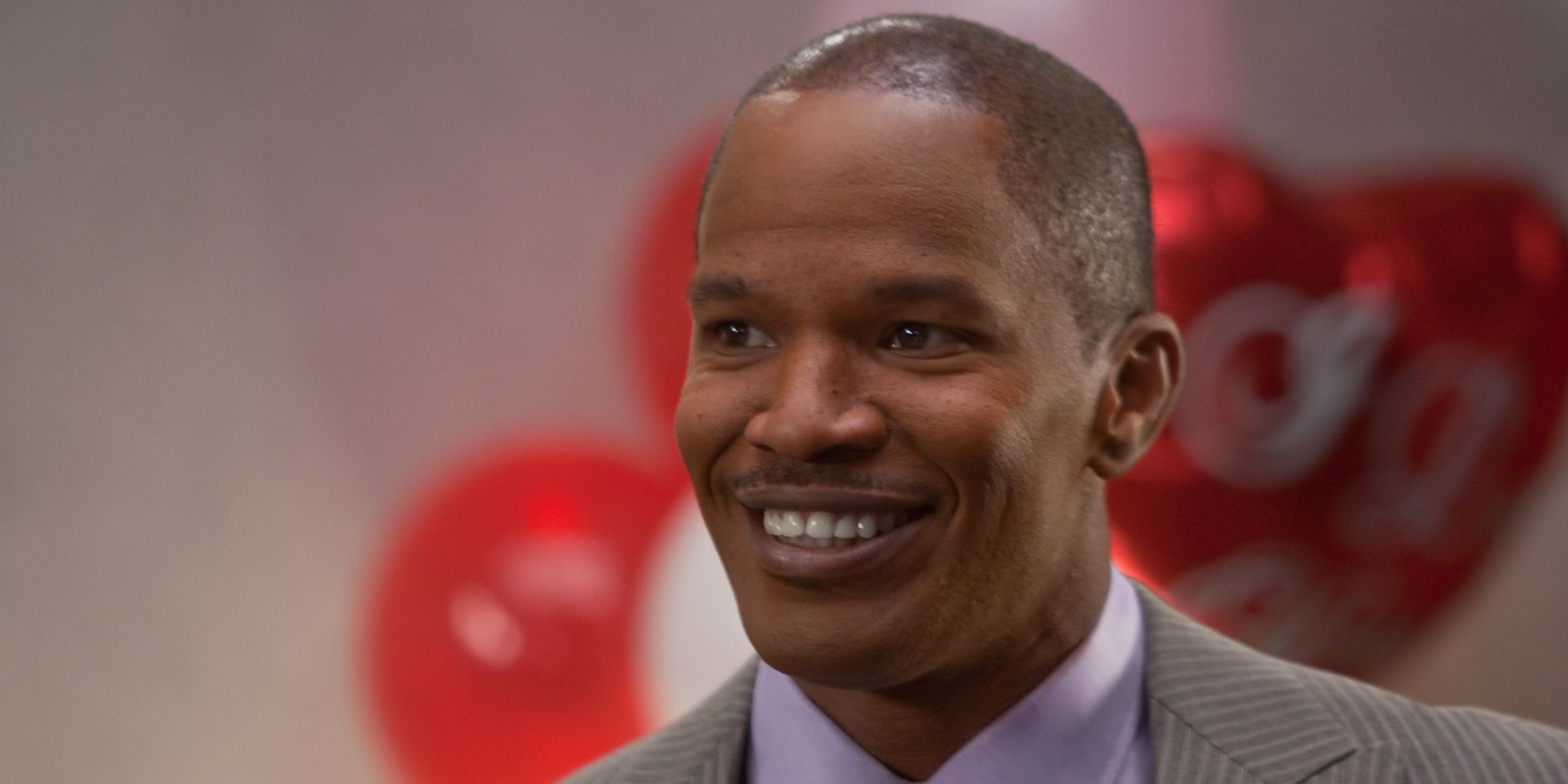 Jamie Foxx smiles awkwardly at a party in Valentine's Day
