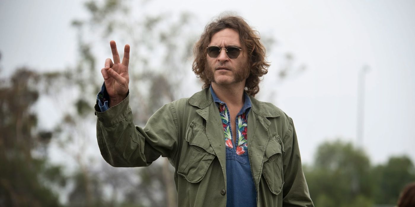 Joaquin Phoenix makes a peace sign in Inherent Vice