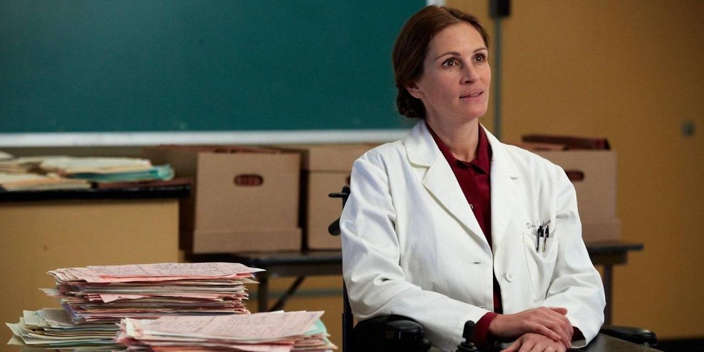 Julia Roberts sitting wearing lab coat in The Normal Heart 
