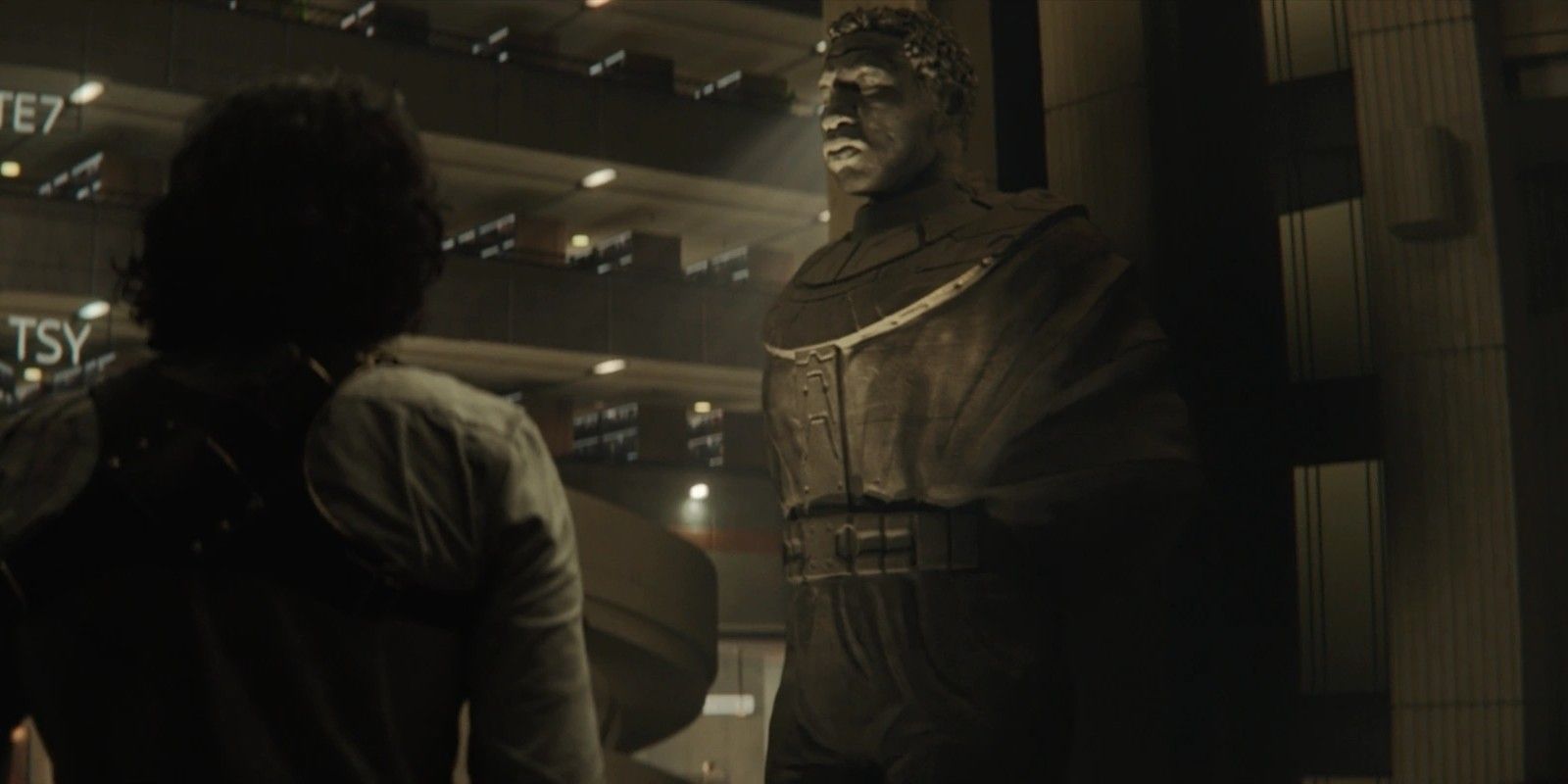 Loki looks at a statue of Kang at the end of season 1
