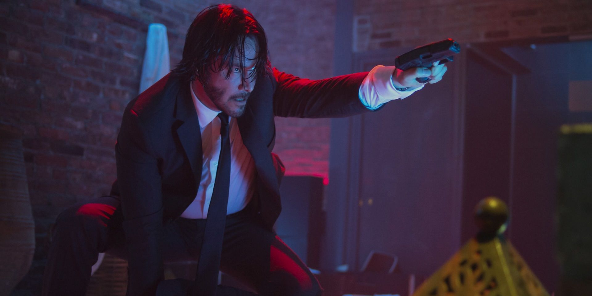 Keanu Reeves with a gun in a club in John Wick