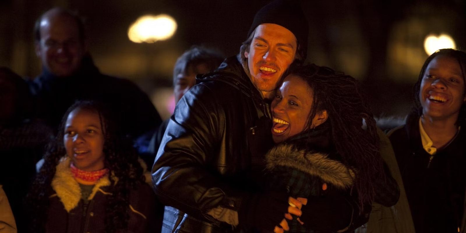 Kevin and Veronica hugging in an outdoor crowd at night on Shameless.