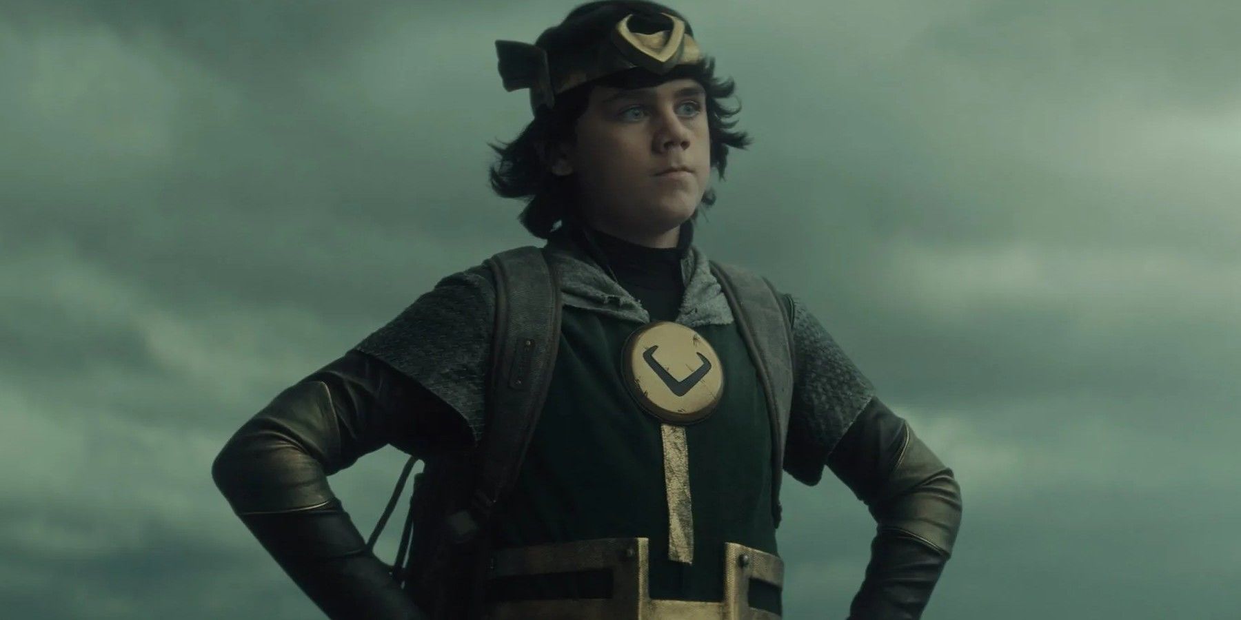 Kid Loki standing with his hands on his hips in Loki