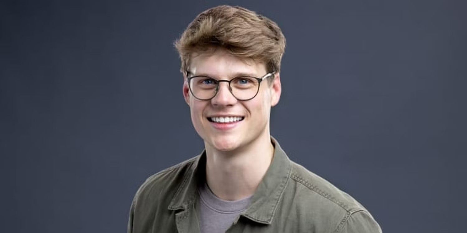 Kyle Capener from Big Brother Season 24 green shirt eyeglasses dark background